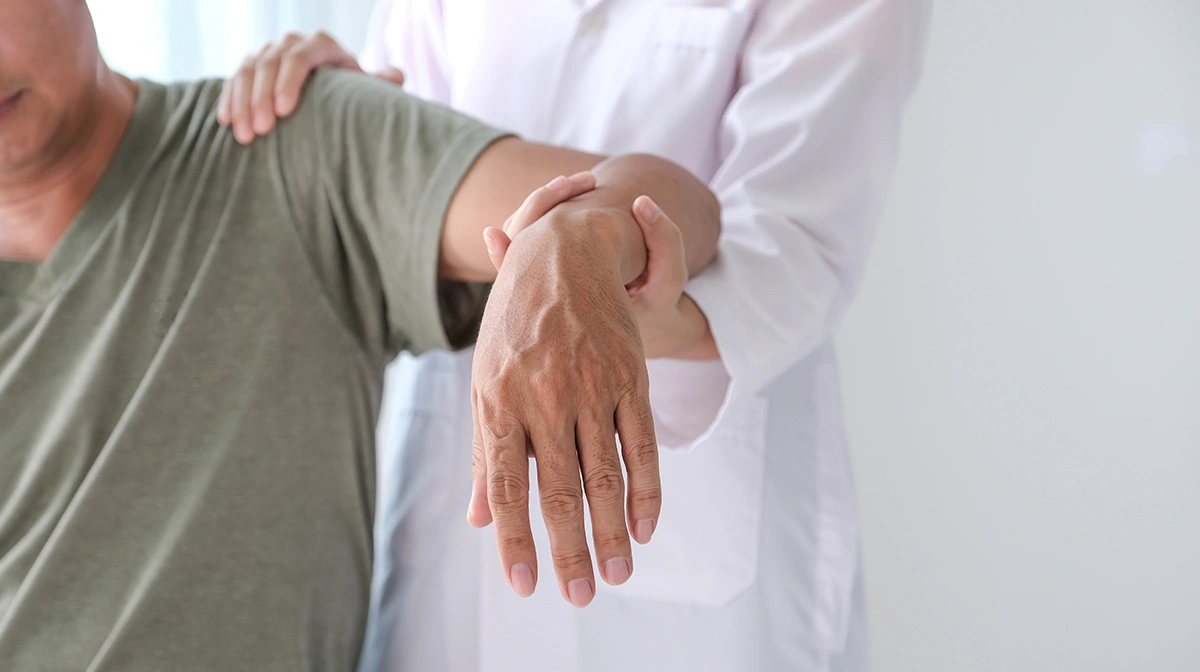 A doctor treating a patient’s shoulder