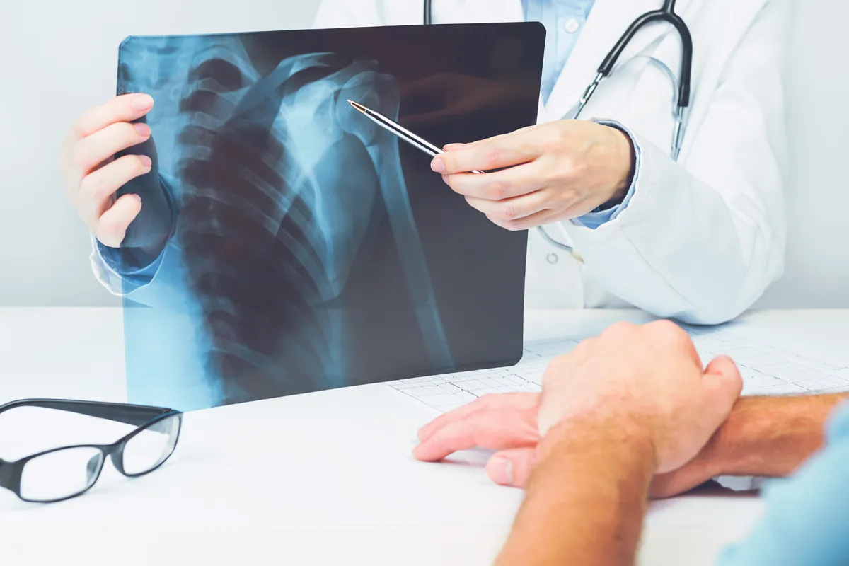Orthopaedic shoulder specialist reviewing a shoulder X-ray with a patient
